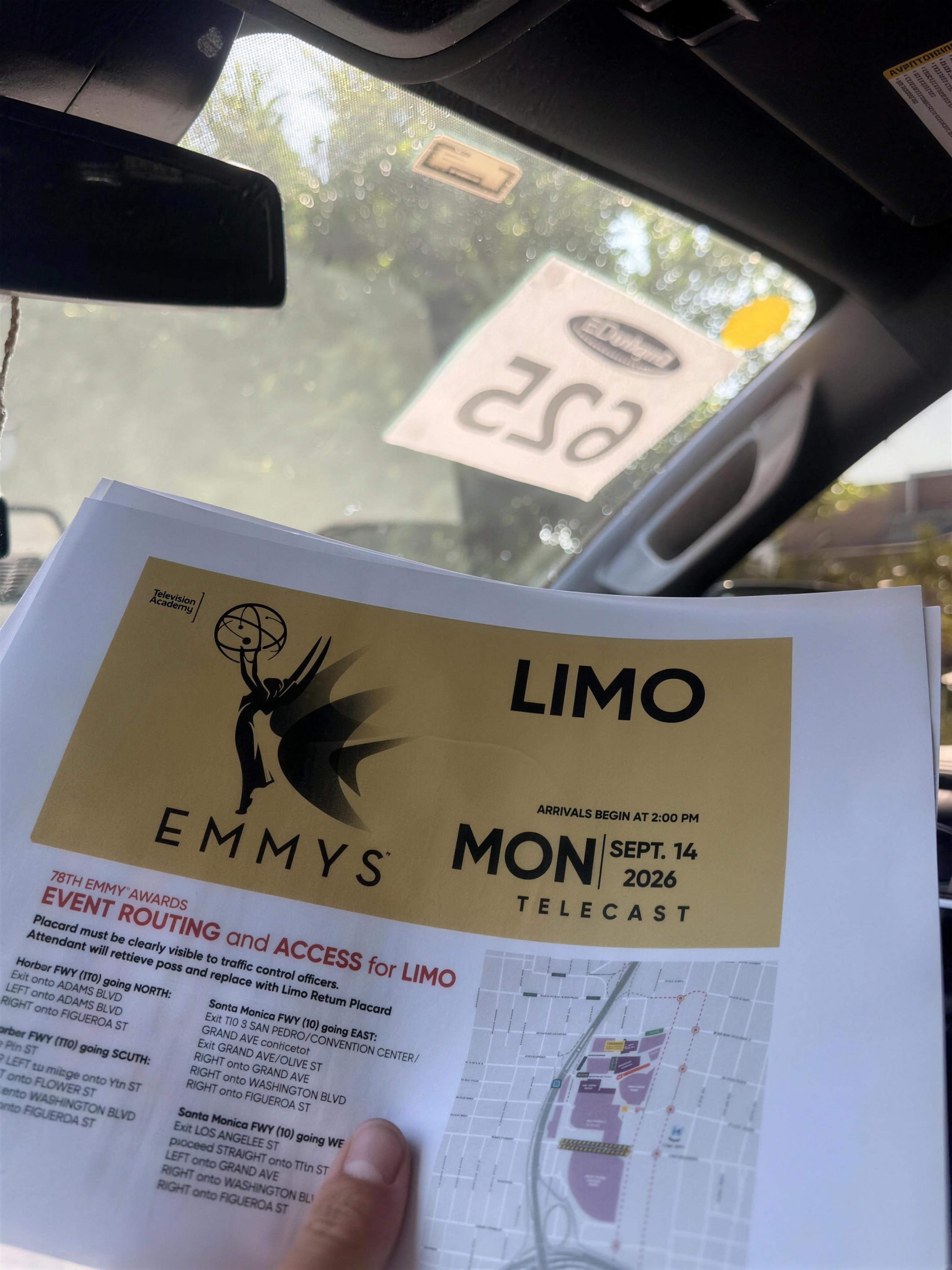 78th Emmy Awards event routing and access placard for LIMO, held up inside the Pacific Elite Rides Suburban